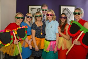 This picture shows Thursfields staff wearing colourful tutus, garlands and sunglasses