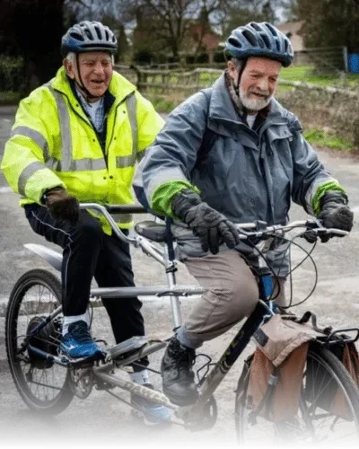 two men riding a tandem together