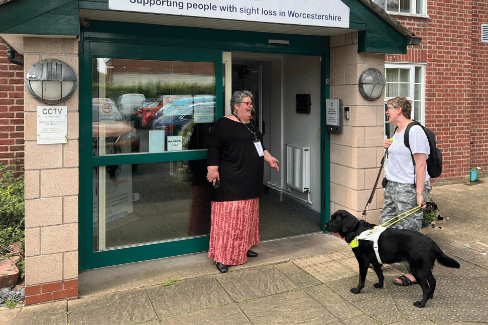 a lady with a guide dog being greeted at the Bradbury Centre