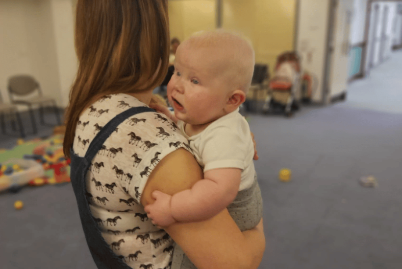 A woman holding a baby in the Bradbury Centre.